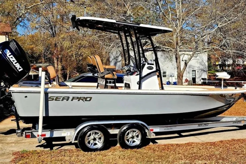 Slide: The Image of 2022 Sea Pro 228 Bay boat on water, featuring Suzuki outboard motor. - 1