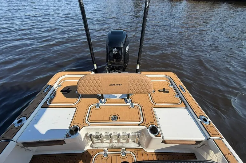 Slide: The Image of 2022 Sea Pro 228 Bay boat deck with motor on calm water. - 10