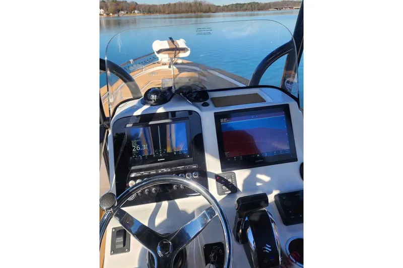 Slide: The Image of 2022 Sea Pro 228 Bay boat on calm water, featuring a powerful 250 engine. - 4