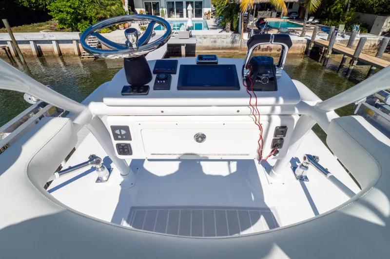 Slide: The Image of 2015 Intrepid 400 Center Console helm with steering wheel and navigation controls. - 102