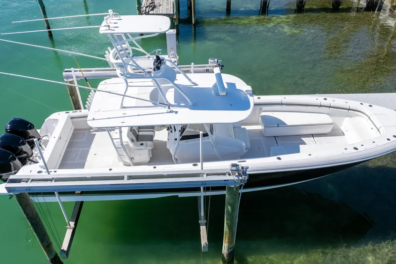 Slide: The Image of 2015 Intrepid 400 Center Console boat on lift over clear water. - 26