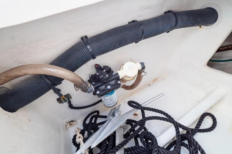 Slide: The Image of 2015 Intrepid 400 Center Console boat interior with hoses, pump, and ropes. - 36