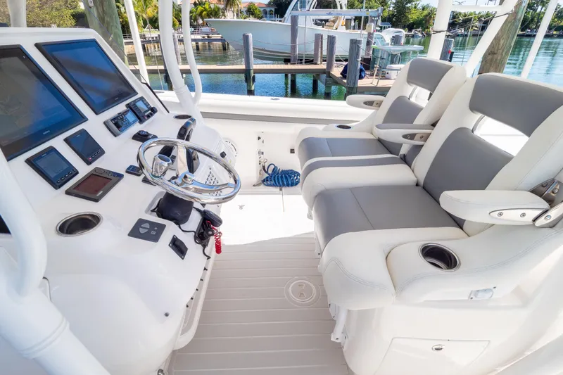 Slide: The Image of 2015 Intrepid 400 Center Console boat cockpit with modern controls and seating. - 53