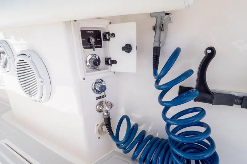 Slide: The Image of Control panel and coiled hose on 2015 Intrepid 400 Center Console boat. - 61