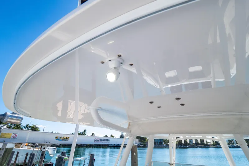 Slide: The Image of 2015 Intrepid 400 Center Console boat with sleek white canopy and lighting. - 66