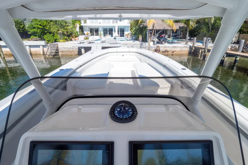 Slide: The Image of 2015 Intrepid 400 Center Console boat at dock, featuring navigation equipment. - 80