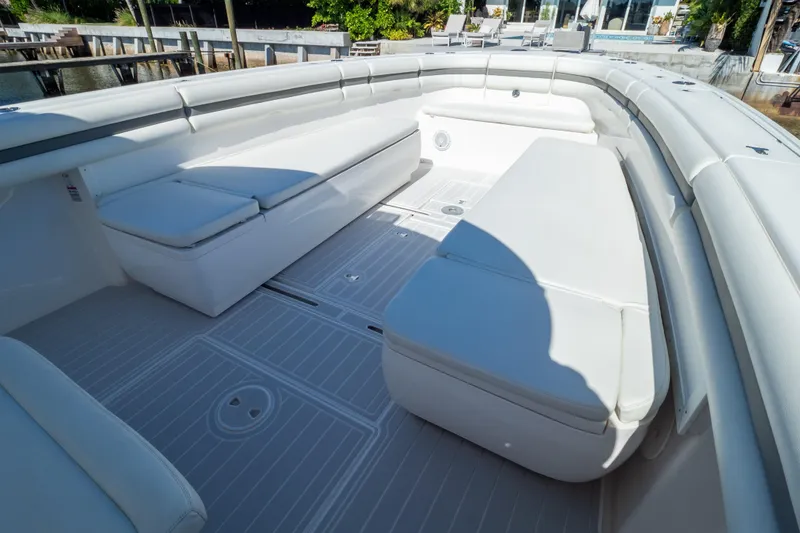 Slide: The Image of 2015 Intrepid 400 Center Console boat with spacious white seating area. - 89