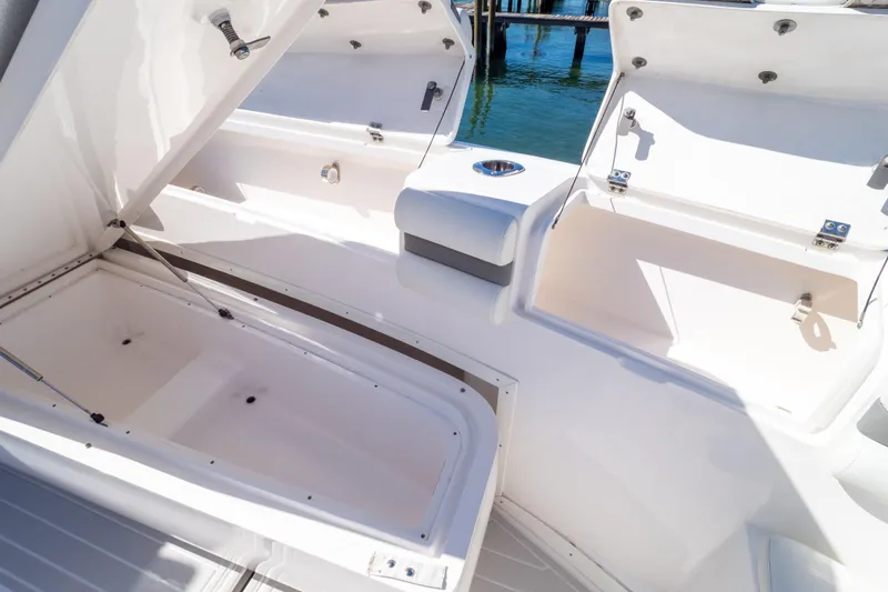 Slide: The Image of 2015 Intrepid 400 Center Console boat storage compartments open on deck. - 91