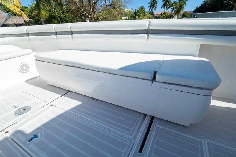 Slide: The Image of 2015 Intrepid 400 Center Console boat seating area with white cushioned bench. - 98