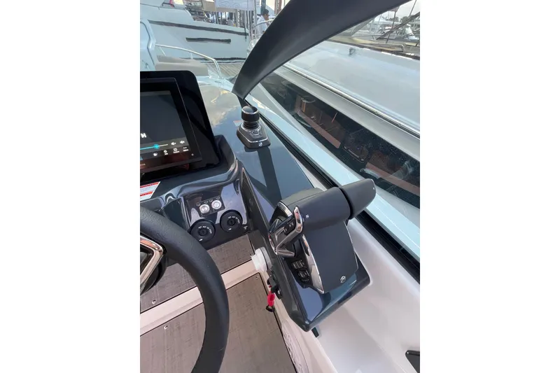 Slide: The Image of Helm of 2026 Jeanneau TH33 boat with modern controls and touchscreen display. - 11