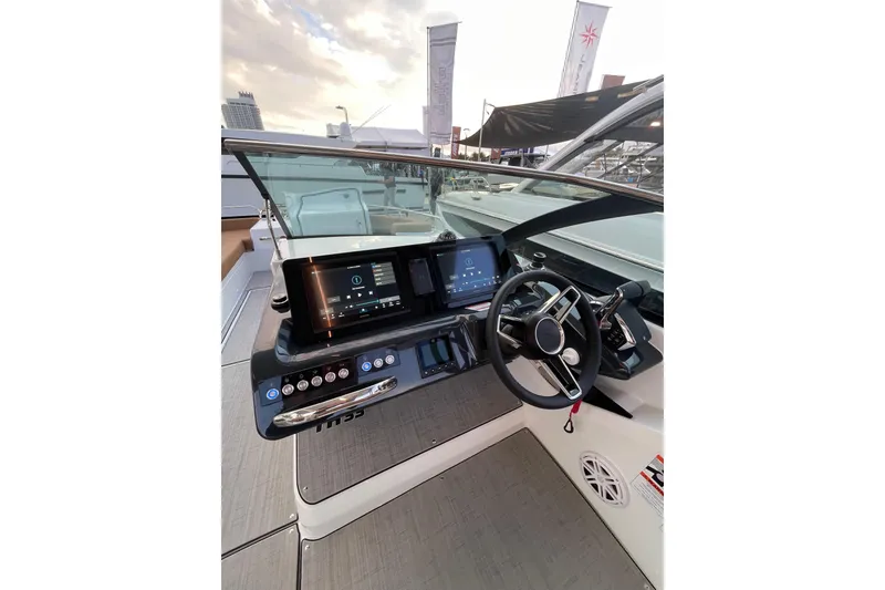 Slide: The Image of 2026 Jeanneau TH33 boat helm with modern controls and dual displays. - 12