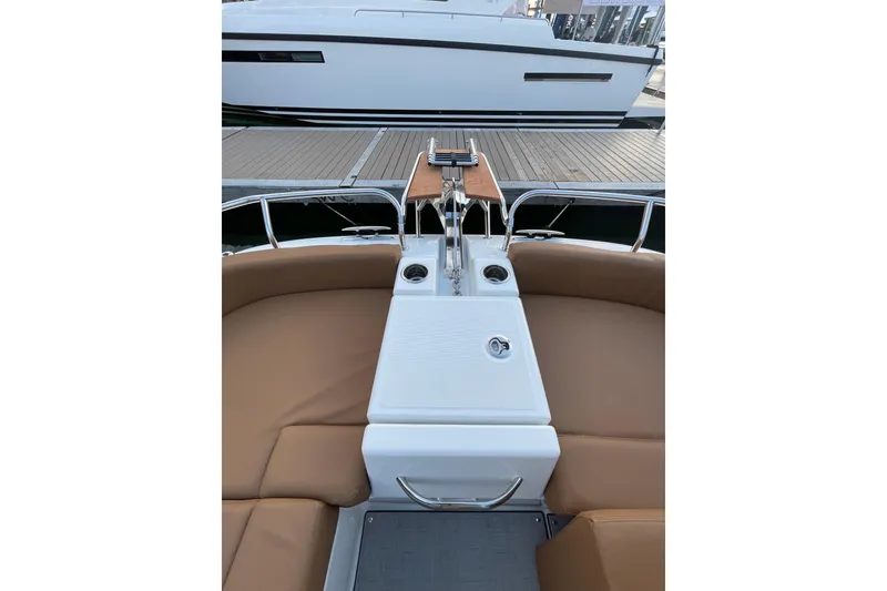 Slide: The Image of 2026 Jeanneau TH33 boat interior with brown seating and sleek design. - 13