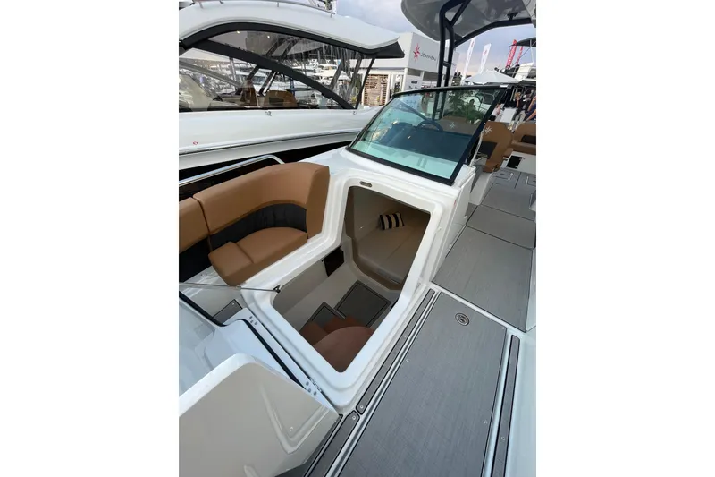 Slide: The Image of 2026 Jeanneau TH33 boat interior with tan seating and modern design. - 16