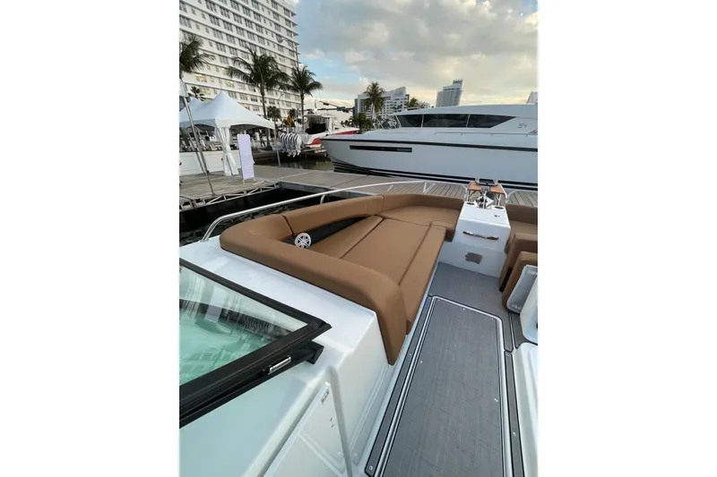 Slide: The Image of 2026 Jeanneau TH33 yacht with luxurious seating at a marina, showcasing modern design. - 17