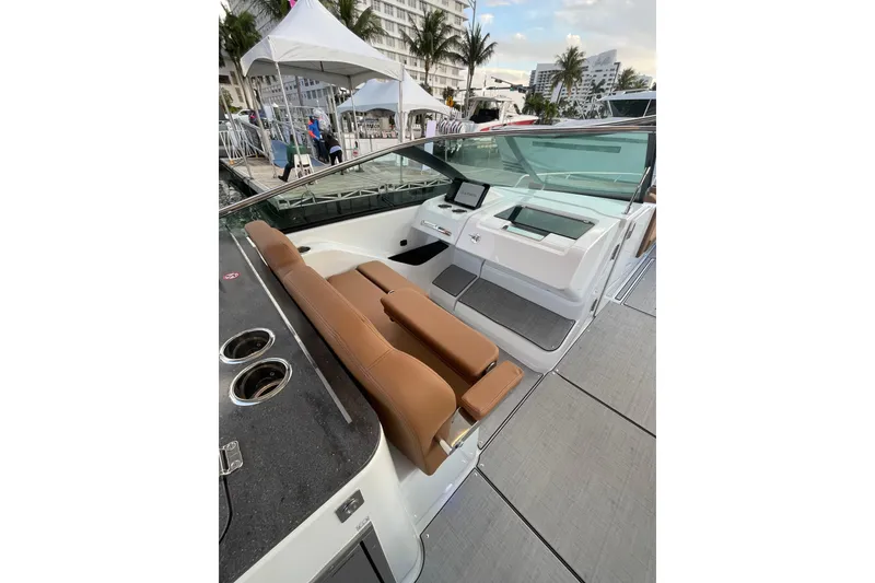 Slide: The Image of 2026 Jeanneau TH33 boat interior with brown seating and modern dashboard. - 18