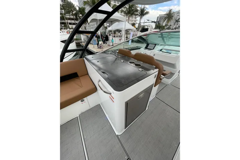 Slide: The Image of 2026 Jeanneau TH33 boat interior with seating and kitchenette, docked at marina. - 20