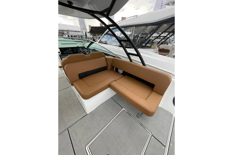 Slide: The Image of 2026 Jeanneau TH33 boat interior with tan seating and modern design. - 24