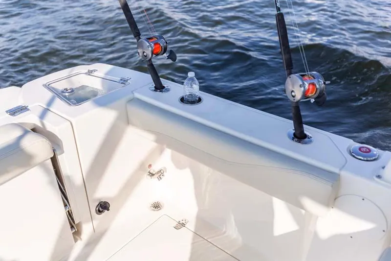 Slide: The Image of Manufacturer Provided Image: 2025 Cobia 240 Dual Console boat with fishing rods and water bottle on deck. - 16