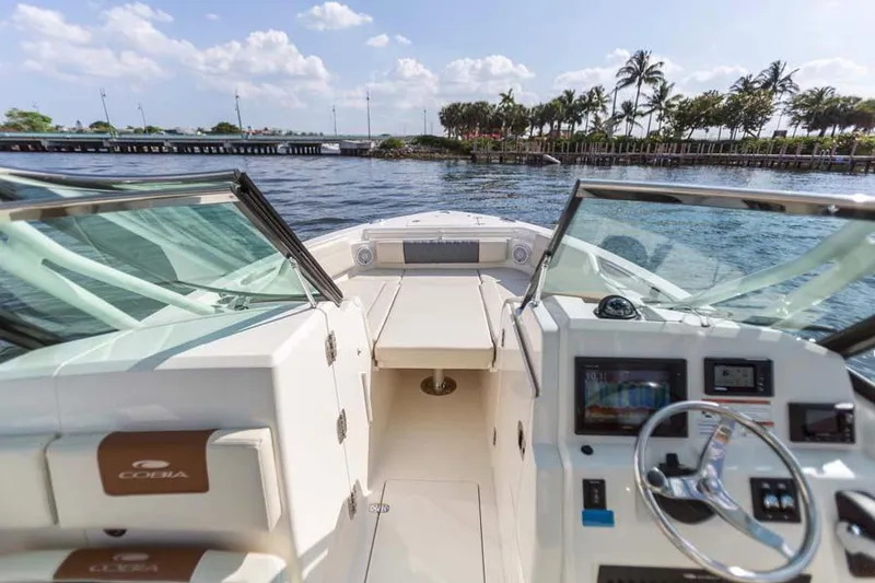 Slide: The Image of Manufacturer Provided Image: 2025 Cobia 240 Dual Console boat interior with scenic waterfront view. - 8