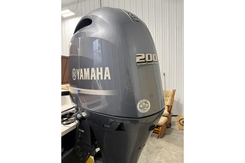 Slide: The Image of Yamaha 200 outboard motor on 2021 Release 210 RX boat, in a garage setting. - 11