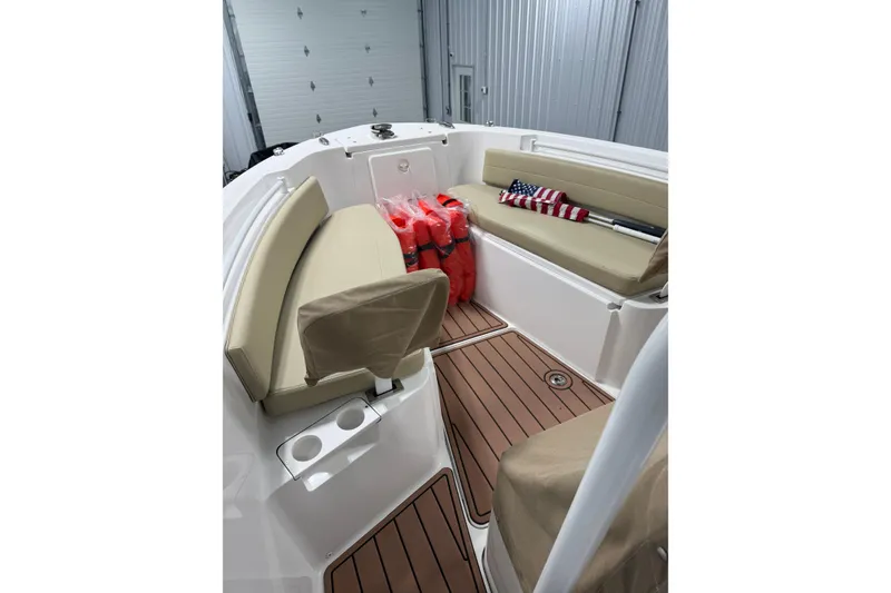 Slide: The Image of Interior of 2021 Release 210 RX boat with beige seating and wooden flooring. - 3
