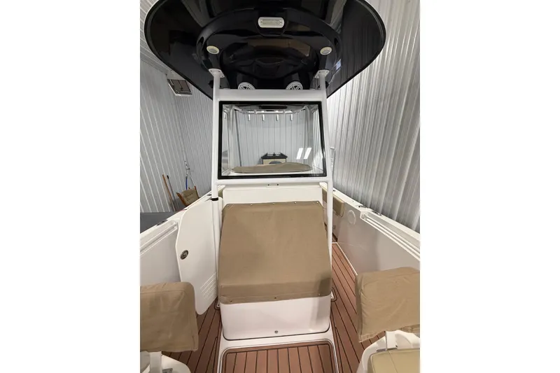 Slide: The Image of 2021 Release 210 RX boat interior with covered seating and sleek design in storage. - 4