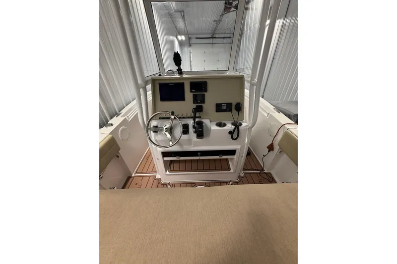 Slide: The Image of Interior view of a 2021 Release 210 RX boat cockpit with steering wheel and controls. - 7