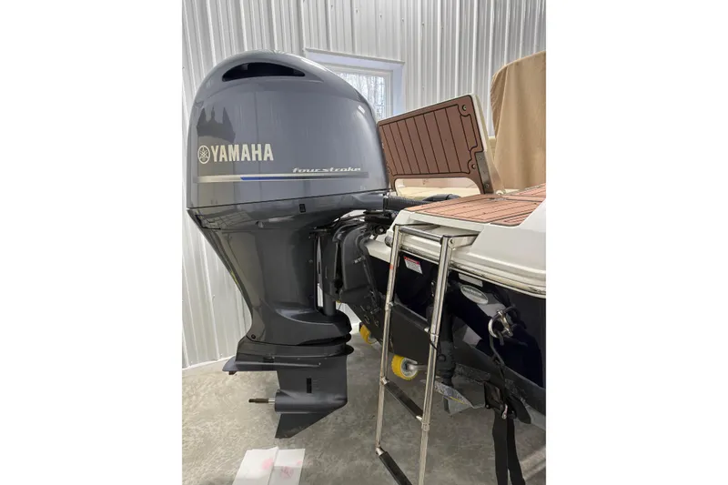 Slide: The Image of Yamaha four-stroke outboard motor on 2021 Release 210 RX boat, in a metal-walled storage area. - 9