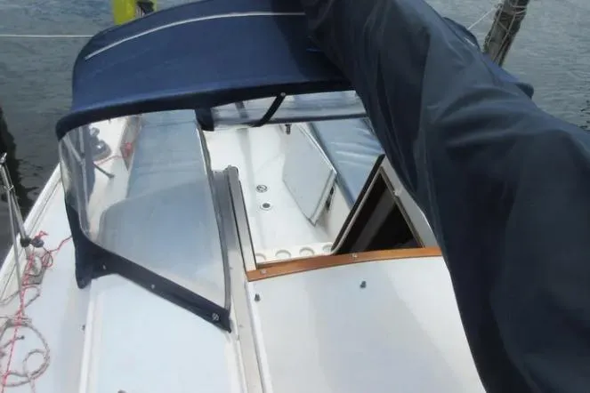 Slide: The Image of 1974 Pearson 30 sailboat cockpit with blue canopy and open cabin hatch. - 6