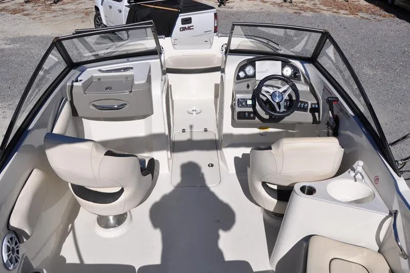 Slide: The Image of 2021 Stingray 201 DS boat interior with steering wheel, seats, and dashboard. - 10