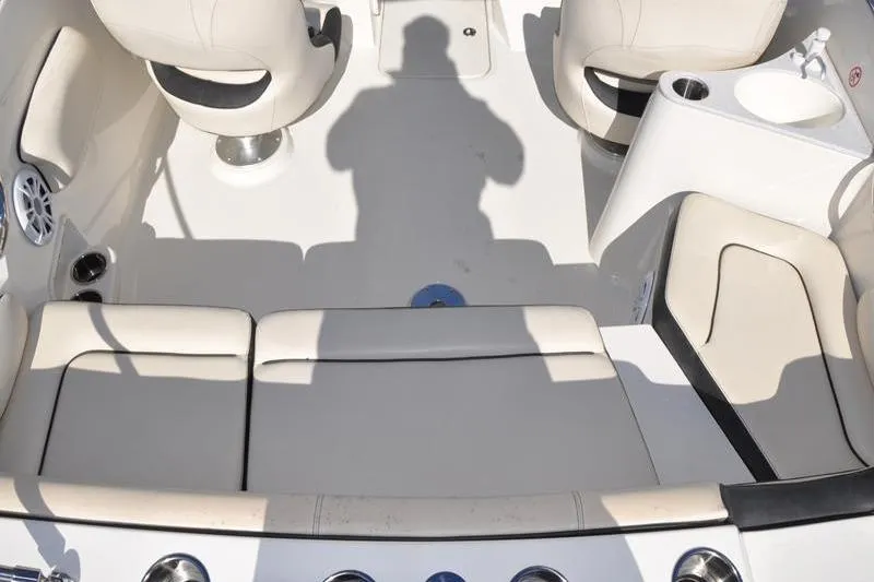 Slide: The Image of 2021 Stingray 201 DS boat interior with white seating and cup holders. - 11