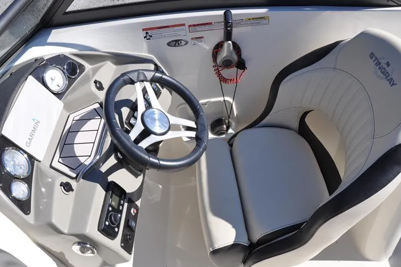 Slide: The Image of Interior of 2021 Stingray 201 DS boat with steering wheel and captain's seat. - 16
