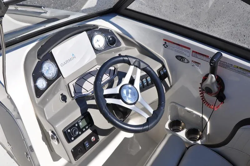 Slide: The Image of 2021 Stingray 201 DS boat dashboard with Garmin navigation and steering wheel. - 17