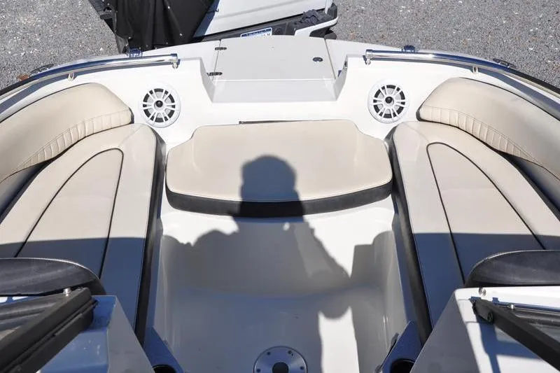 Slide: The Image of 2021 Stingray 201 DS boat interior with beige seating and speaker system. - 19