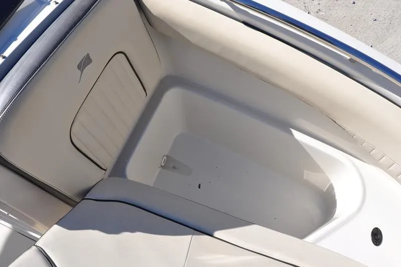 Slide: The Image of Interior view of 2021 Stingray 201 DS boat, featuring spacious seating and storage area. - 23