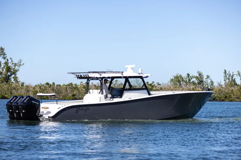 Slide: The Image of 2023 Yellowfin 42 boat cruising on a calm waterway. - 3
