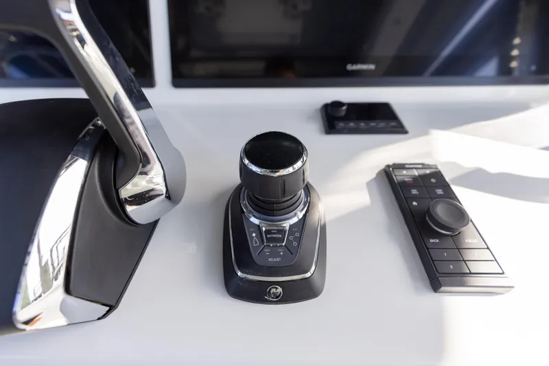 Slide: The Image of Control panel of a 2023 Yellowfin 42 boat with joystick and throttle. - 48