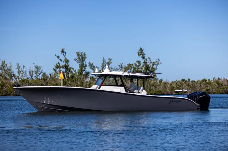Slide: The Image of 2023 Yellowfin 42 boat cruising on a calm waterway. - 9