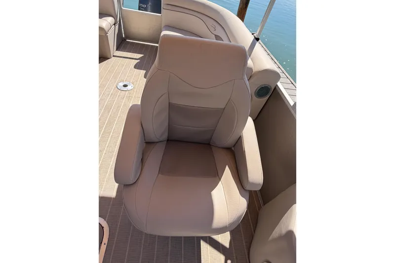 Slide: The Image of Luxurious seating on 2018 Bennington 24 SSRX pontoon boat, beige upholstery, waterfront view. - 11