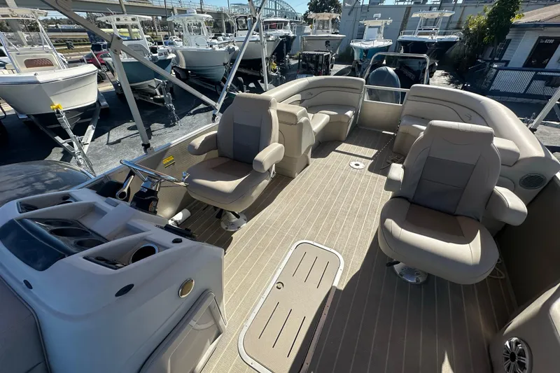 Slide: The Image of 2018 Bennington 24 SSRX pontoon boat interior with beige seating and steering console. - 14