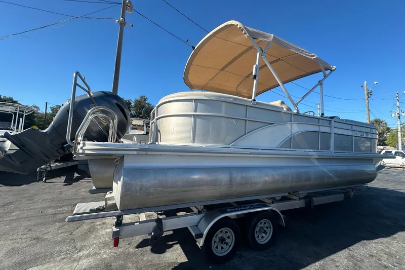 Slide: The Image of 2018 Bennington 24 SSRX pontoon boat on trailer with canopy and Yamaha outboard motor. - 3