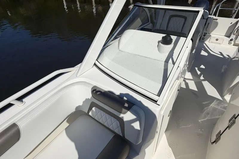 Slide: The Image of 2023 World Cat 255 DC boat interior with white seating and windshield. - 13