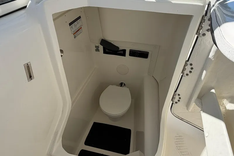 Slide: The Image of 2023 World Cat 255 DC boat interior with compact marine toilet. - 17