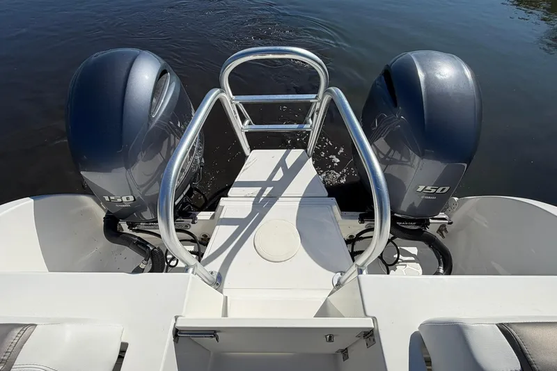 Slide: The Image of 2023 World Cat 255 DC boat with dual Yamaha 150 engines on water. - 21