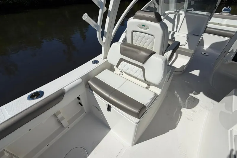 Slide: The Image of 2023 World Cat 255 DC boat interior with cushioned seating and rod holders. - 23