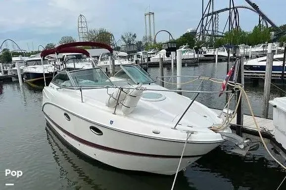 The Image of 2007 Maxum 2600 SE boat docked in marina, surrounded by other vessels. - 0