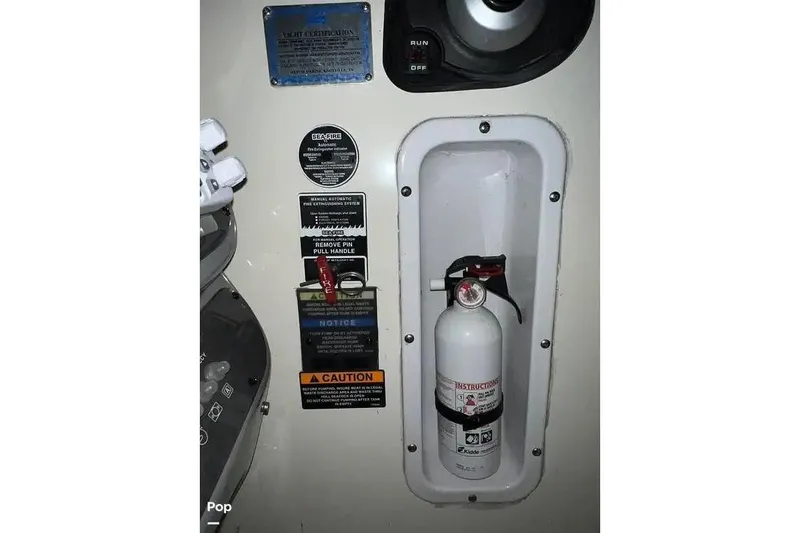 Slide: The Image of Fire extinguisher in 2007 Maxum 2600 SE boat, mounted with safety instructions. - 11