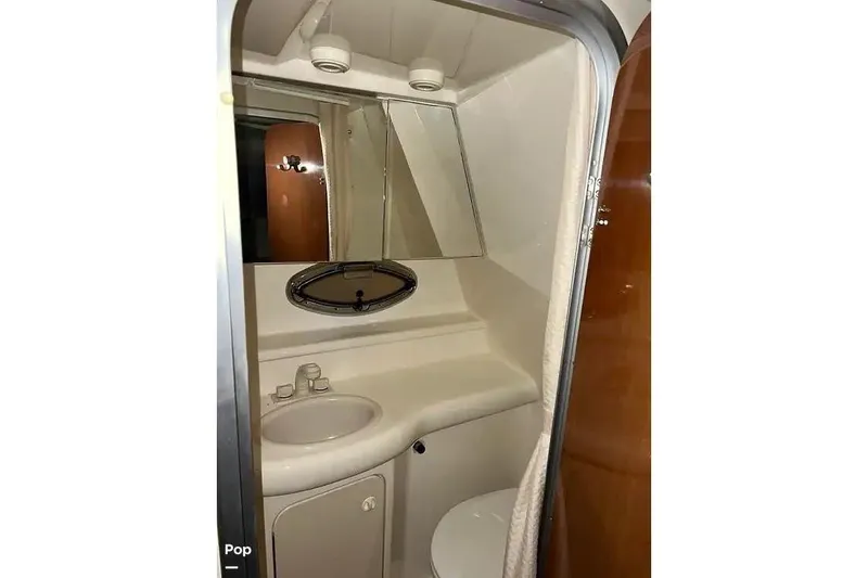 Slide: The Image of 2007 Maxum 2600 SE boat bathroom with sink, mirror, and compact design. - 12