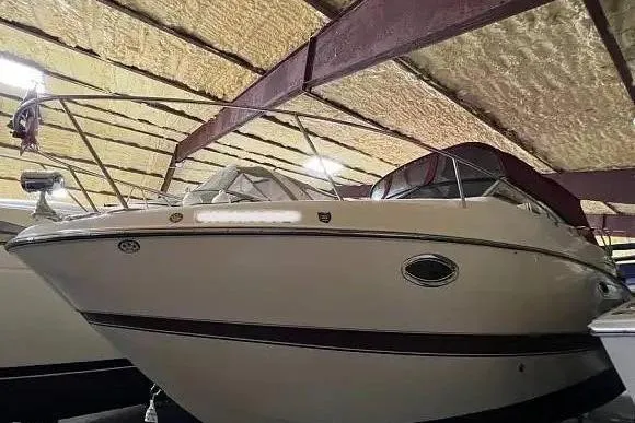 Slide: The Image of 2007 Maxum 2600 SE boat in covered storage, side view. - 2