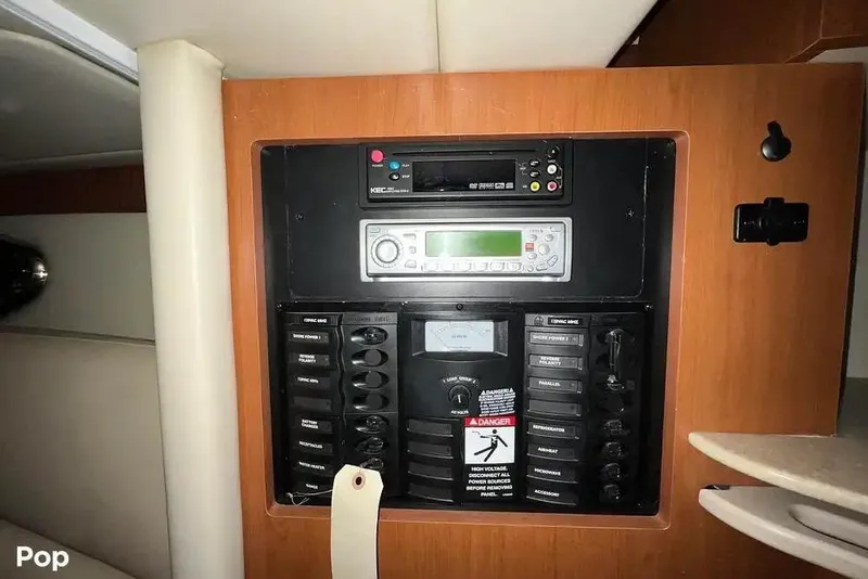 Slide: The Image of Control panel inside 2007 Maxum 2600 SE boat, featuring audio and electrical systems. - 5